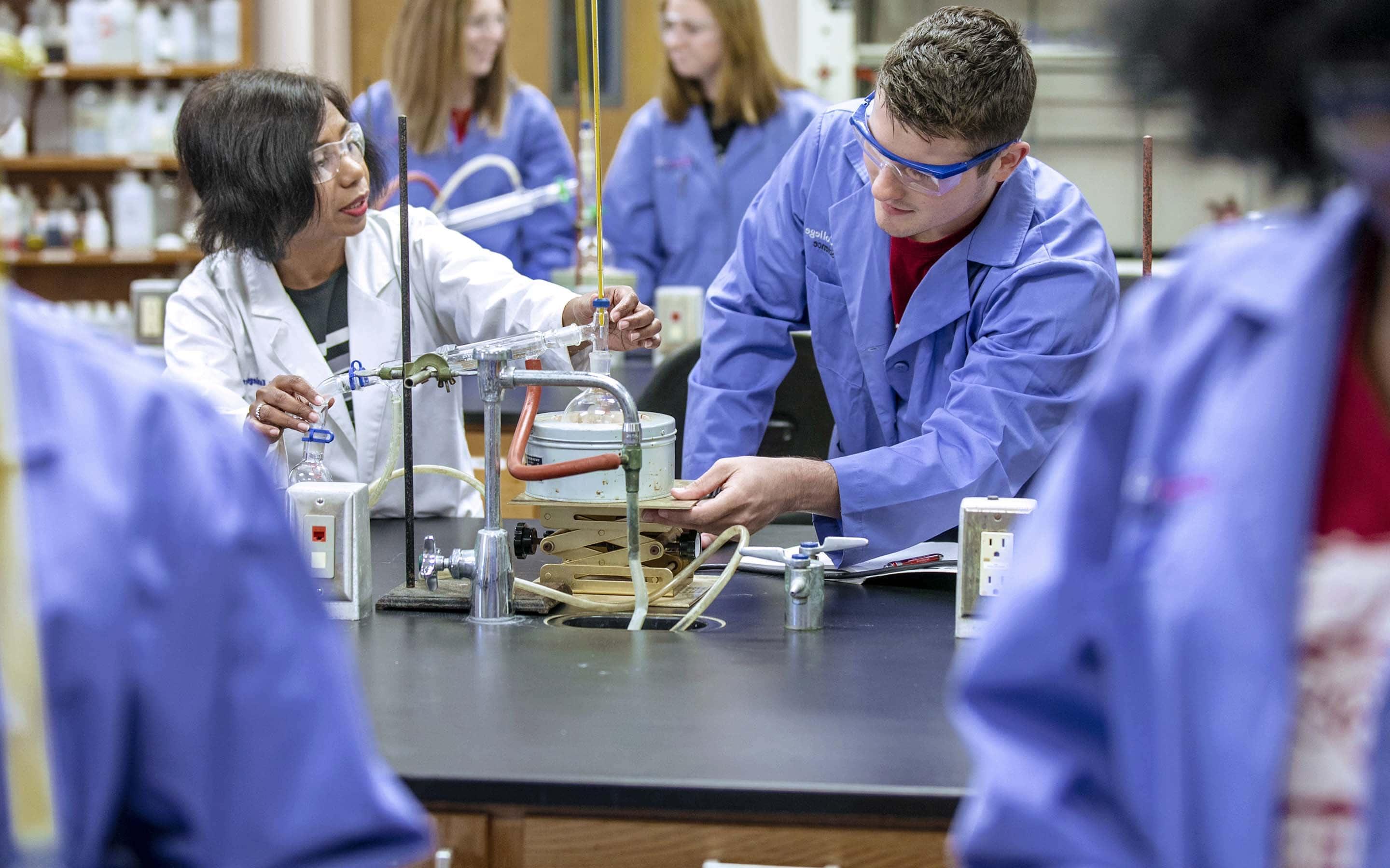 Manjula Koralegedara, professor of chemistry, with MC students.